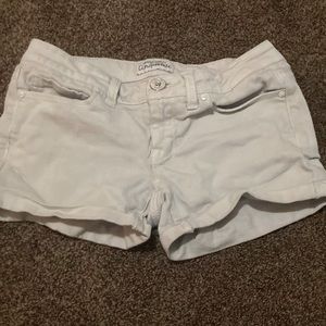 White pair of low waisted jean shorts.